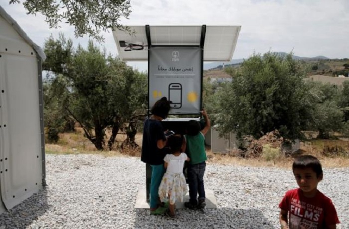 Sun-powered phone charger gives migrants in Greece free electricity